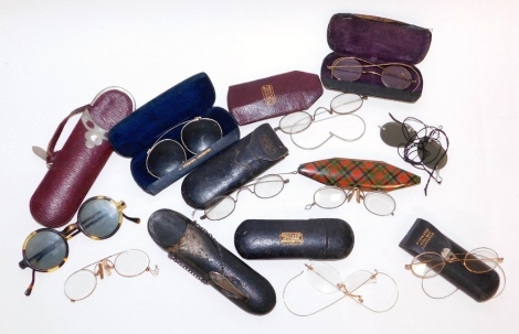 Various pairs of gilt framed spectacles and sunglasses, a tartan ware spectacles case, etc.