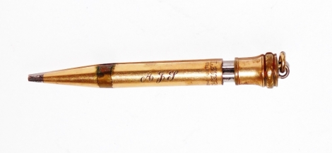 A gilt metal pencil, bearing the initials AJJ, 7cm high, with a loop cast end.