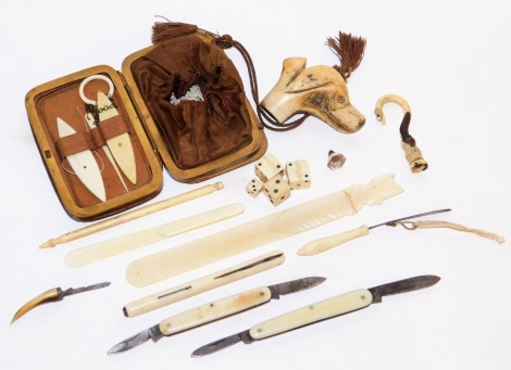 A group of late 19thC ivory trinkets, dice and pen knives, and a walking stick ivory topped dog's head.