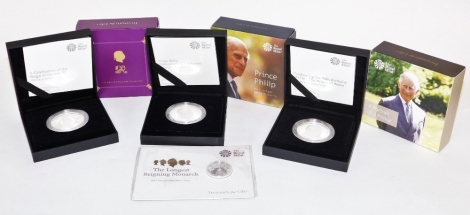 Four Royal Mint collectors coins, to include a portrait of a Prince, Prince Philip Not For Himself But For His Country, I Glory In The Name Of Britain Treasure For Life, boxed, and a cased twenty pound fine silver coin, The Longest Reigning Monarch 2015. 