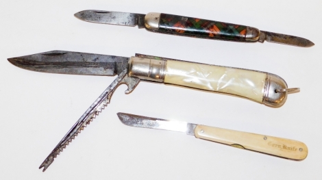 Three pen knives, to include a tartan effect and stainless steel pen knife, a corn knife in ivory casing and a stainless steel and mother of pearl inlaid pen knife. (3)