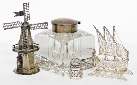 A group of small silver and white metal, to include a silver topped and cut glass inkwell, Birmingham 1936, 6cm high, a white metal filigree ship, 6cm high, a novelty white metal windmill figure with makers stamp JDH and lion symbol, 8cm high, together wi