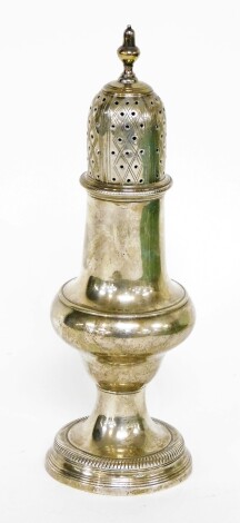 A George III silver pepper pot, of baluster form with pierced top and ribbed stem foot, London 1782, 16cm high, 3oz.