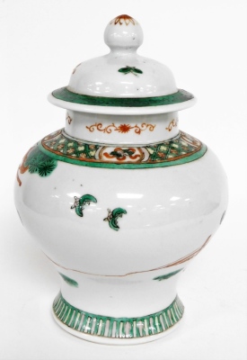 A Chinese ginger jar and cover, heavily decorated with green and red borders, and figures under trees, with character stamp to underside, 23cm high. - 3