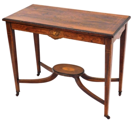 An Edwardian side table, with banded borders and oval centre panel with cherub oval shields to each end, above four splay base with fan detailing on taper legs, 74cm high, 90cm wide, 43cm deep.