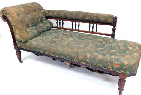 A Victorian chaise longue, with mahogany back supports and overall floral green upholstery, 80cm high, 177cm wide, 63cm deep. (AF)