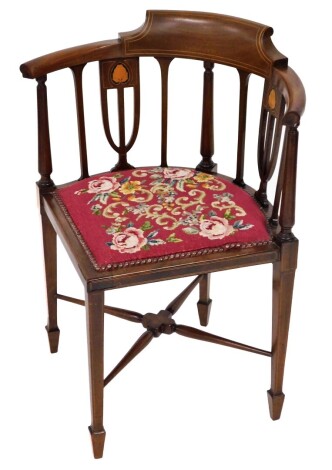 An Edwardian walnut corner chair, with red floral tapestry seat and marquetry detailing, 74cm high, 57cm wide, 48cm deep.