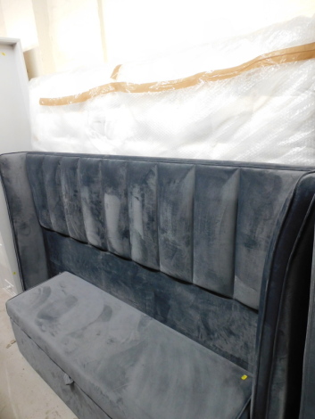 A modern grey material finish king size bed, with headboard, two split bases, mattress and an ottoman bed end.