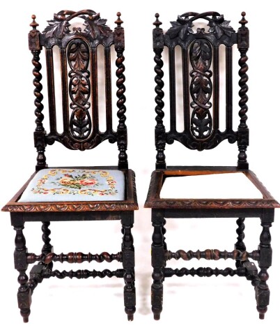 Two carved late 19thC carved oak side chairs, each with barley twist supports, leaf carved panels on drop in tapestry seats, 109cm high, 44cm wide, 41cm deep.