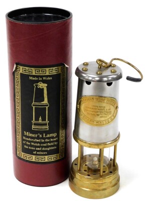 A Welsh miners lamp, with modern fitments, in presentation tube, for The British Coal Mining Company Wales UK, serial number 359144, 21cm high.