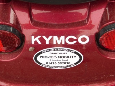 A Protec Mobility Kymco red mobility scooter. - 2