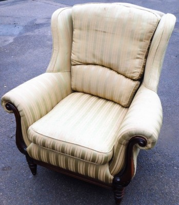 A mahogany framed armchair, with green and gold Regency striped fabric upholstery, on scrolling padded arms, on later castors, 128cm high, 92cm wide, 90cm deep.