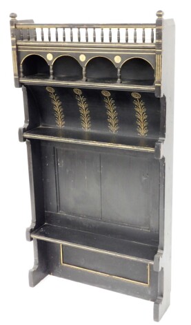 A Victorian ebonised aesthetic movement dresser top, the top with bobbin and arch panels, on floral engraving, with two shelf section and gilt inlays, 143cm high, 77cm wide, 18cm deep.