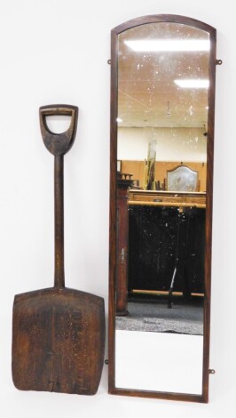 An oak framed mirror, and a wooden malt shovel. (2)