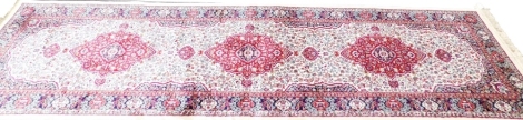 An ivory ground full pile cashmere runner, with floral medallion, 300cm x 180cm.