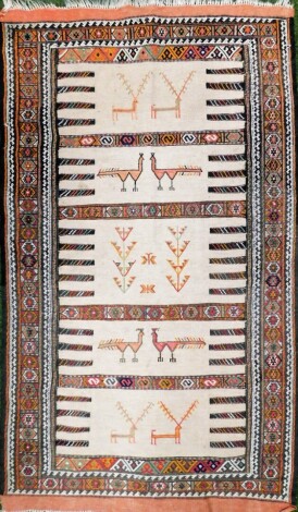 An Iranian kilim rug, on a cream weave design with medallion borders, with birds and animals and tassel ends, 153cm x 88cm.