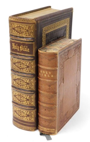 Two leather bound Holy bibles, each with gilt tooled detailing.