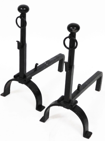 A pair of metal andirons, with ringed and hooked top, 55cm high, 44cm wide.