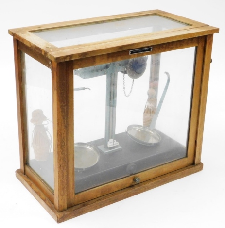 A Griffin and George limited cased chemists weighing scale, 40cm high, 46cm wide, 22cm deep.