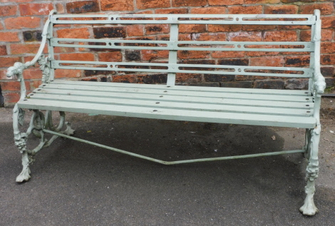 A Coalbrookdale style cast garden bench, painted green with dog terminal arm rests, on grapevine and snake cast ends, the base on wooden slats, 82cm high, 151cm wide, 62cm deep.