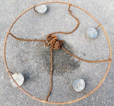 A hanging circular candle stand, with four brackets, 82cm diameter.