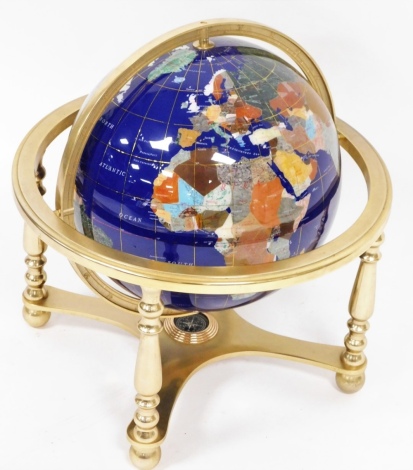 A hardstone terrestrial globe, on blue finish, on a base with compass bottom, 46cm high, 44cm diameter.