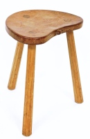 A Robert Thompson of Kilburn 'Mouseman' oak three legged stool, with shaped seat with carved mouse, on three taper legs, 45cm high, 37cm wide, 29cm deep.