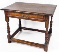 A 17thC and later oak side table, with three plank top, single frieze drawer with brass swan neck handle, on turned legs with moulded stretchers, 69cm high, 84cm wide, 56cm deep.