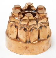 A Victorian copper jelly mould, in a castle turret form of six points, numbered 284, 12cm high, 14cm diameter.