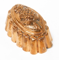 A Victorian copper jelly mould, of oval design with embossed pineapple top, makers stamp and numbered 1A, 12cm high, 17.5cm wide.