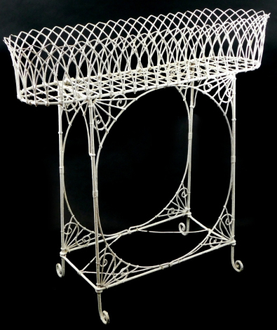 A 19thC wire work jardiniere or plant stand, decorated with arches on end supports with brackets and under tier, 87cm high, 93cm wide, 26cm deep.