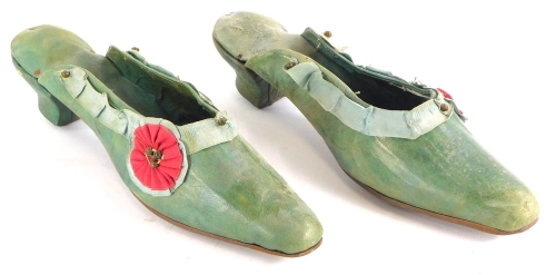 A pair of 19thC ladies green leather shoes, embellished with fabric rosette and cut steel, 25cm long.