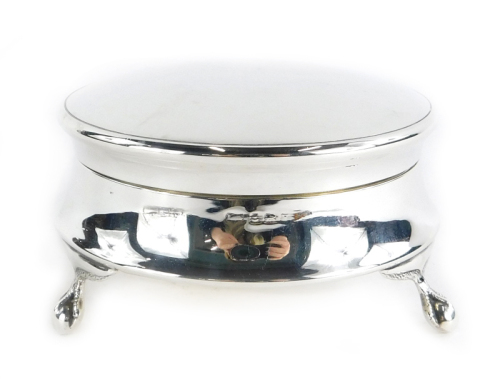 A George V silver trinket or powder box, with a plain circular hinged lid, on claw and ball feet, Birmingham 1945, 3¼oz, 4.5cm high, 8.5cm wide.