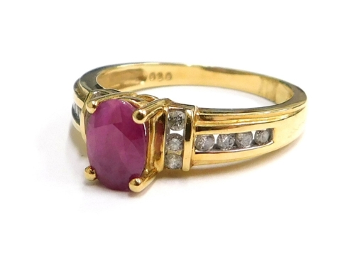An 18ct gold ruby and diamond dress ring, the oval and cut ruby in four claw setting, with six diamond set shoulders, six diamond set supports, and eight diamond set shoulders, ring size N½, 3.5g all in.