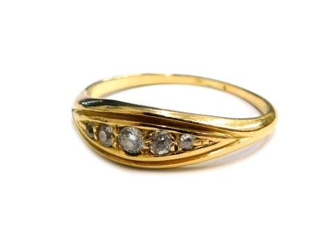 A diamond set dress ring, set with five tiny diamonds in diamond shaped ring head, in a yellow metal setting, unmarked, ring size K, 2.4g all in.