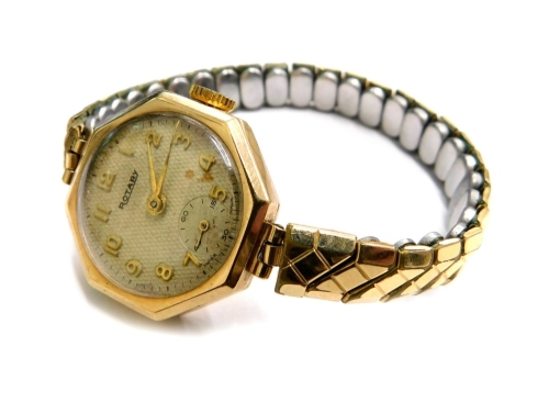 A Rotary 9ct gold wristwatch, with octagonal watch head, the silvered dial with gold hands, on a gold plated expanding bracelet, 17.5g all in.