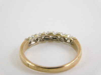 A 9ct gold half hoop eternity ring, set with seven round brilliant cut diamonds, in claw white gold setting, on a yellow metal band, ring size N½, 2.3g all in. - 2