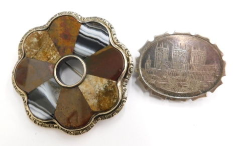 Two silver brooches, to include an oval silver brooch depicting Lincoln Cathedral, 4cm wide, together with a silver framed and agate stone set flower brooch, 5cm wide, 36.7g all in.