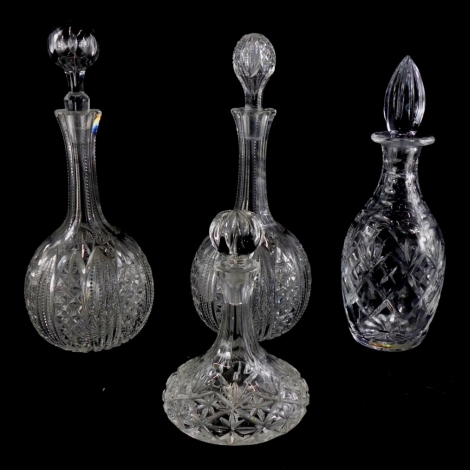 A pair of cut glass bottle shaped decanters and associated stoppers, and two other further cut glass decanters. (4)