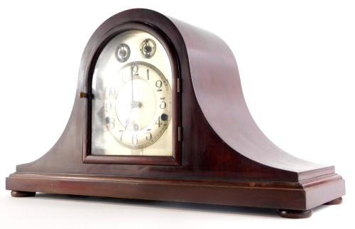 An early 20thC mahogany mantel clock, with Westminster chime in Napoleons hat shaped case, the movements stamped Made In Germany, 54cm wide.