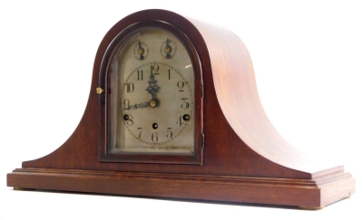 An early to mid 20thC mahogany mantel clock, with Westminster chime, German brass movement and Napoleons hat shaped case, 54cm wide.