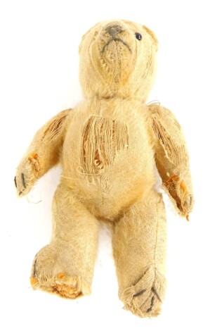 An early 20thC small teddy bear, with straw filling, one eye, (AF), 21cm long.