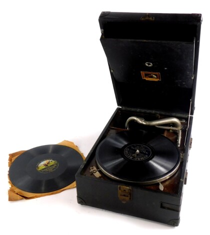 A HMV black canvas cased portable gramophone, with single 78 record.