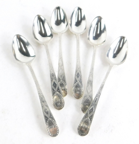 A set of six Georgian silver teaspoons, with bright cut engraved decoration and initialled WJS to the handle, 2¼oz.