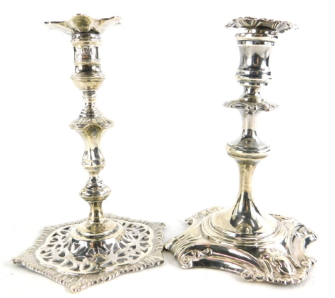 A Victorian taper candlestick, with foliate and scroll decoration, with detachable drip pan, on a shaped square loaded base, London 1893, 11.5cm high, and a similar Victorian silver taper candlestick, with a pierced and leaf cast base, London 1892, 3¾oz, 