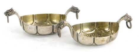 A pair of 20thC Scandinavian small white metal dishes, by Marius Hammer, formed as Viking type ships, each with a pair of mythical beast head handles with rings in each mouth, the bases with hammered decoration, marked 830 to base, (2).