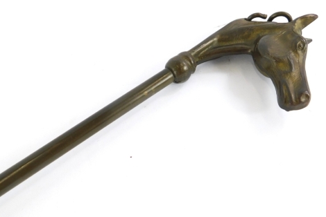 A brass shoe horn, the handle cast with a racehorse, 47cm long.