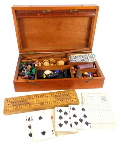 A late 19th/ early 20thC mahogany games box or compendium, to include draughts, cribbage, dominoes, etc.