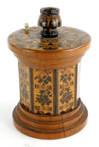 A 19thC Tunbridge ware sealing wax outfit, the lid applied with a candle sconce and a turned ivory fitting, the base decorated with mosaic flowers, etc., 13cm high.