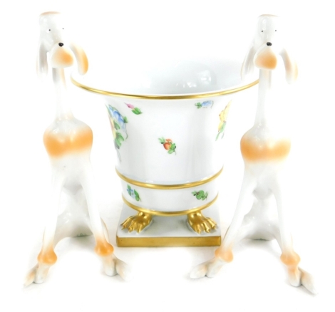 A Herend porcelain vase, decorated with flowers, on three paw feet with square base, 13cm high, and a pair of Hungarian Hollohaza ceramic poodles.